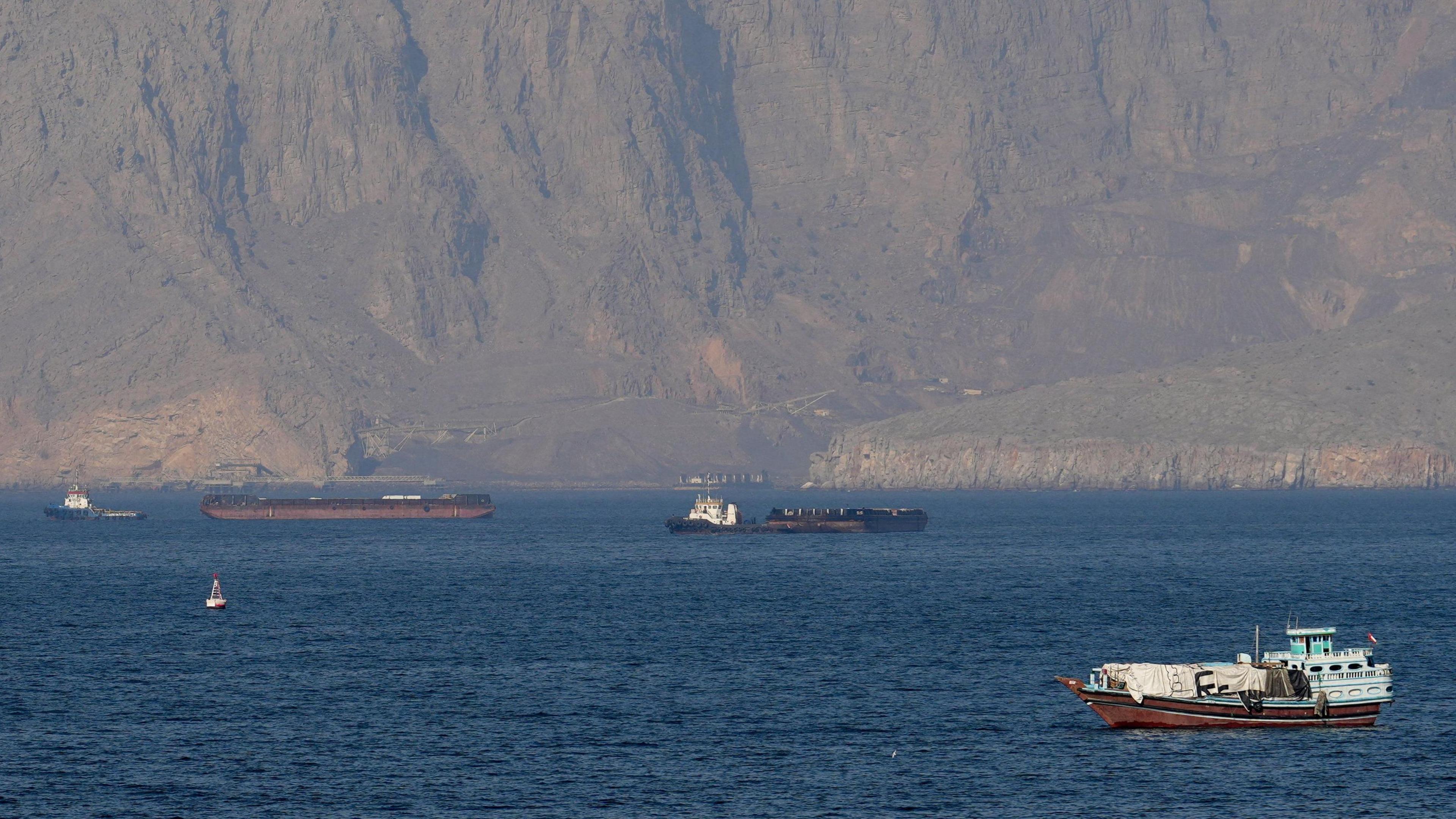 Strait of Hormuz closed again, Iran says, as ships attacked - BBC News