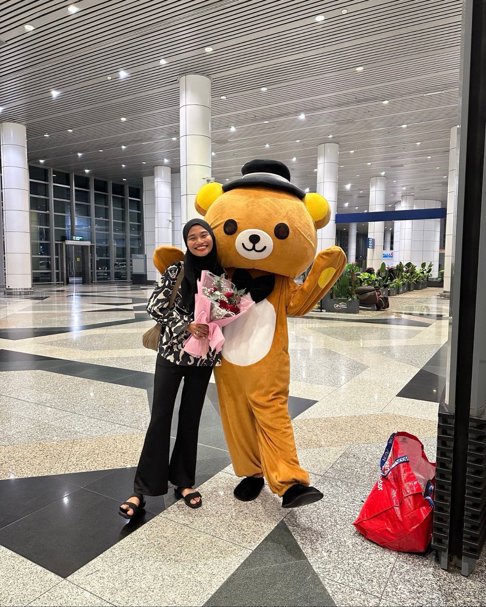丈夫穿着Rilakkuma熊吉祥物迎接妻子
